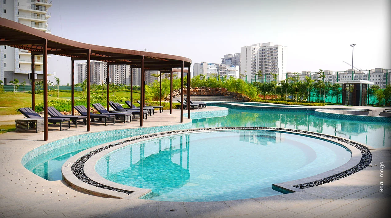 Swimming pool and poolside loungers at M3M Fairway East, Sector 65 Gurugram