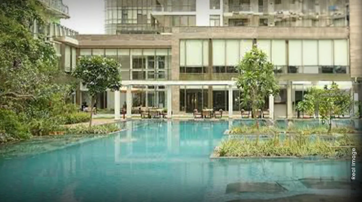 Poolside deck surrounded by lawns at M3M Fairway West, Sector 65 Gurugram