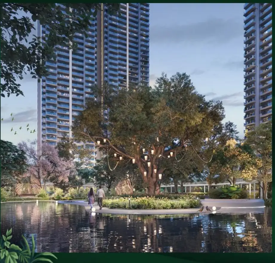 M3M Forestia West 3 BHK towers overlooking the illuminated Central Grove lake at dusk, Manesar Gurugram