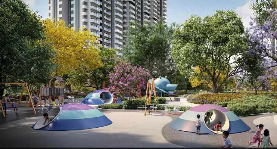 Children's play area with sculptural play forms and flowering trees at M3M Forestia West