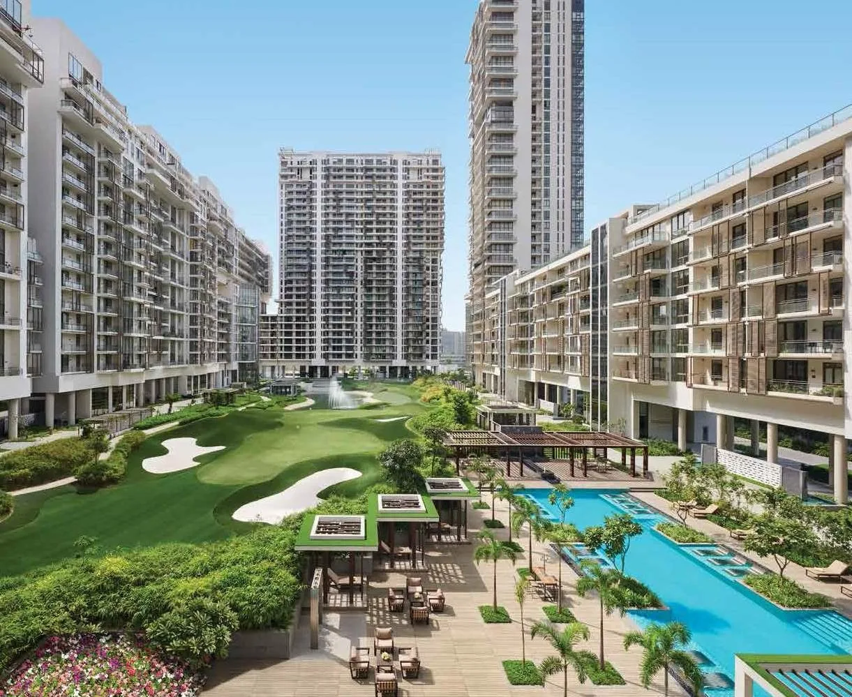 Courtyard swimming pool and golf greens framed by the towers at M3M Golf Estate