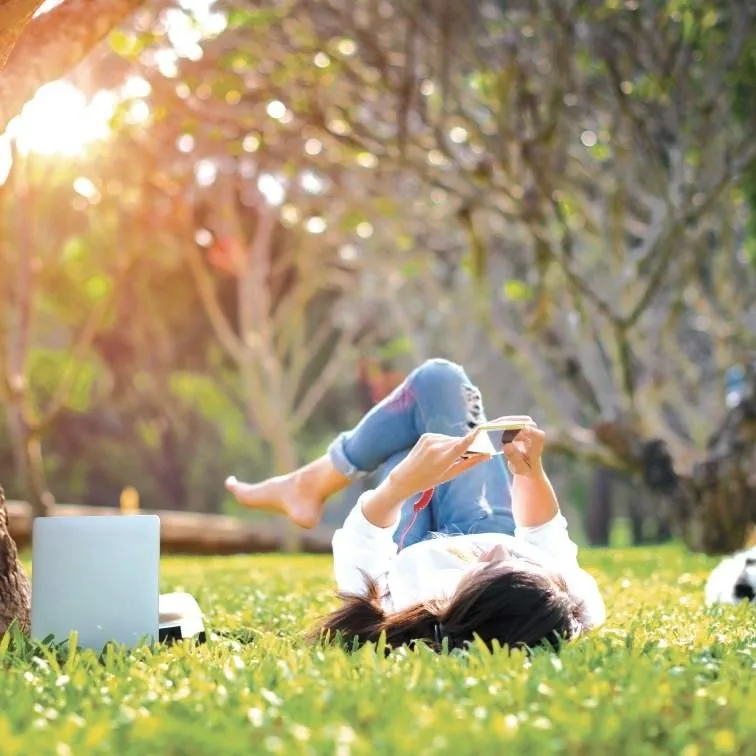 Resident relaxing outdoors in the green landscape at M3M Soulitude
