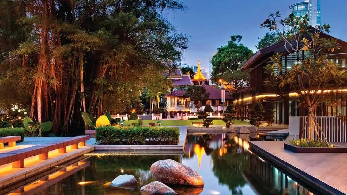 Landscaped clubhouse gardens with water and evening lighting at M3M The Cullinan